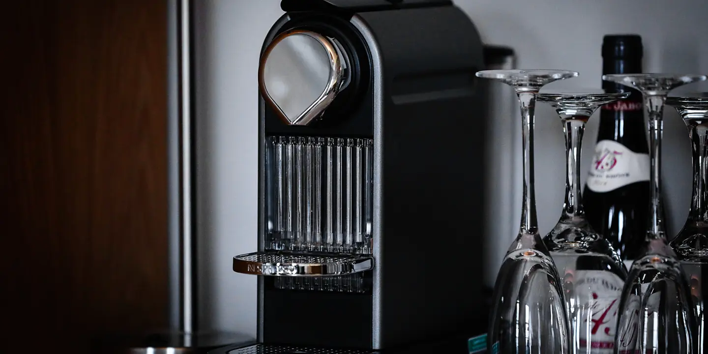 Coffee machine next to some champaign glasses.