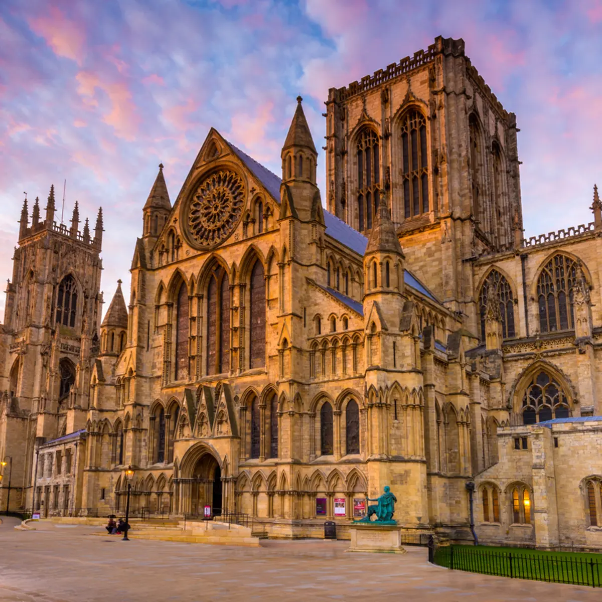 A grand cathedral featuring a prominent clock on its façade.