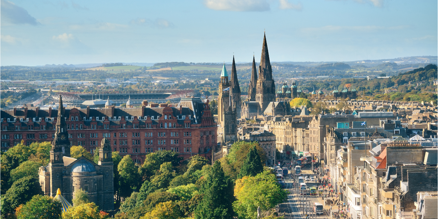 An urban landscape featuring towering buildings and lush trees.