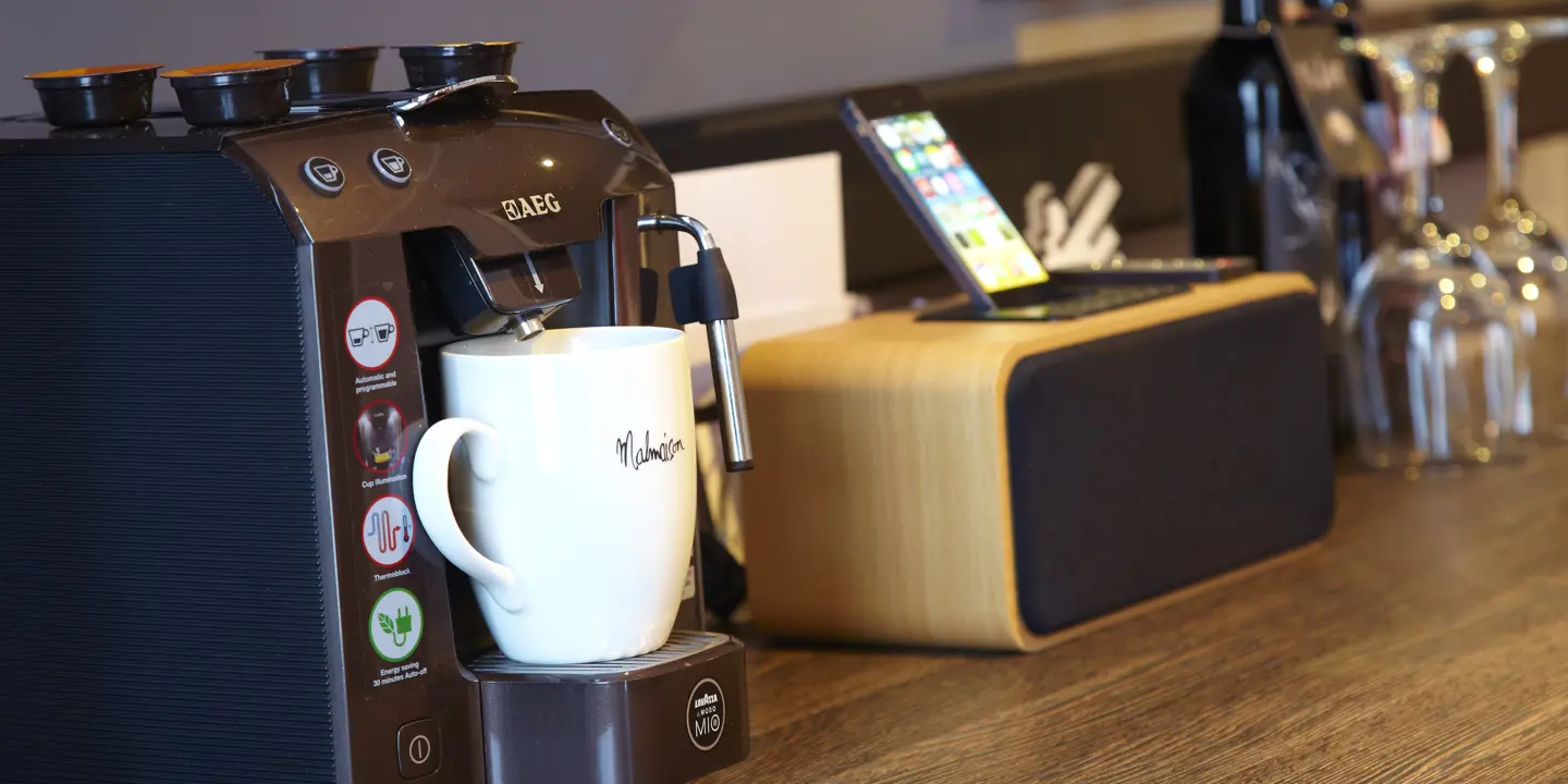 A coffee machine placed on a wooden table.