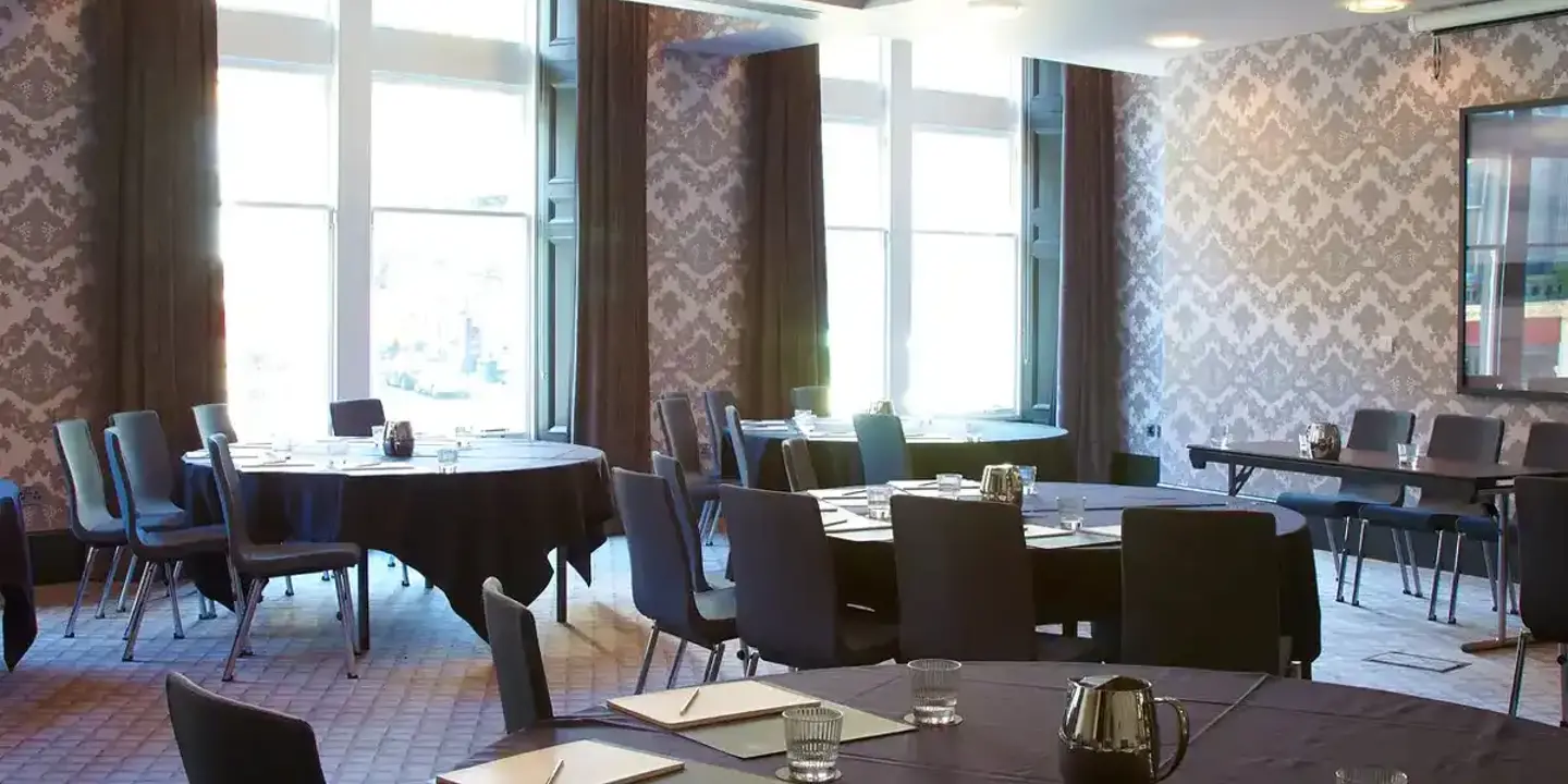 A dining room featuring a round table and chairs.