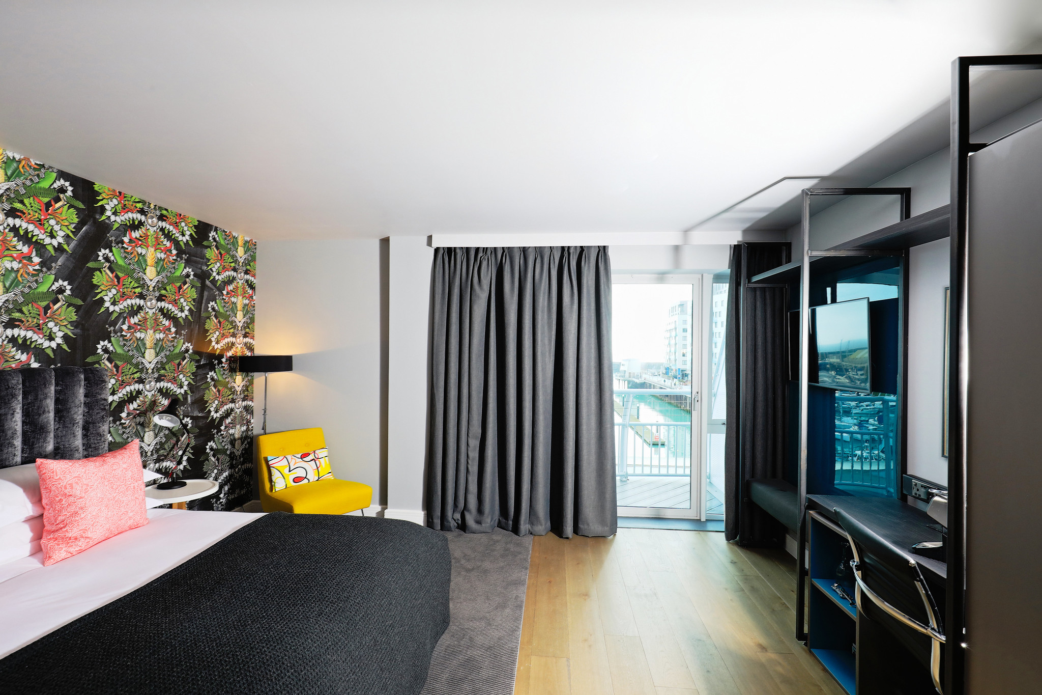 Spacious bedroom featuring a king-sized bed and a charming balcony.