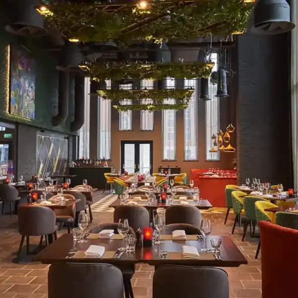 A restaurant featuring tables, chairs, and a spacious window.