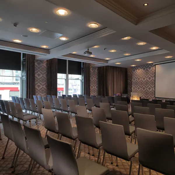 Conference room featuring a spacious table and chairs.