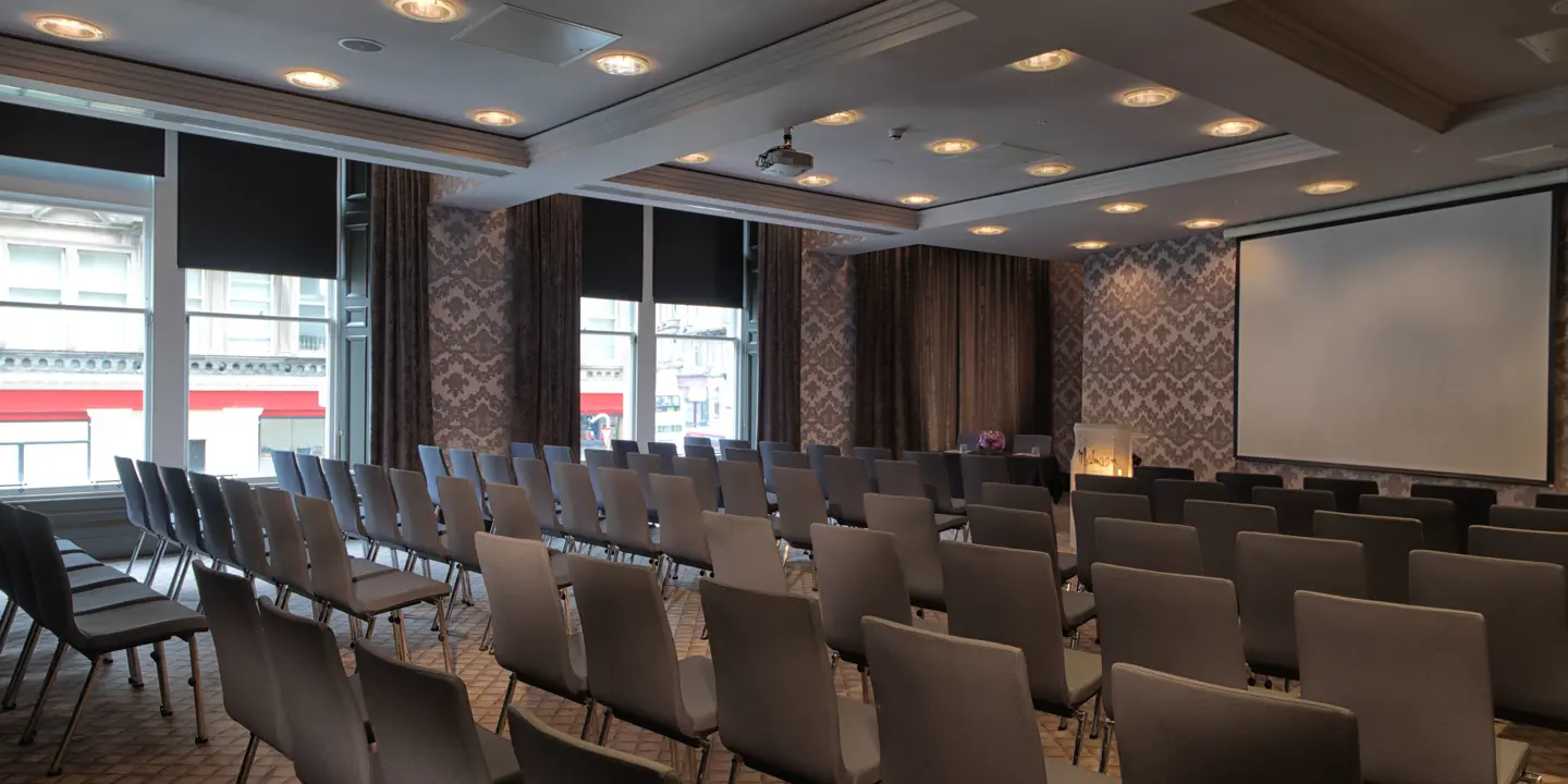 Conference room featuring a spacious table and chairs.