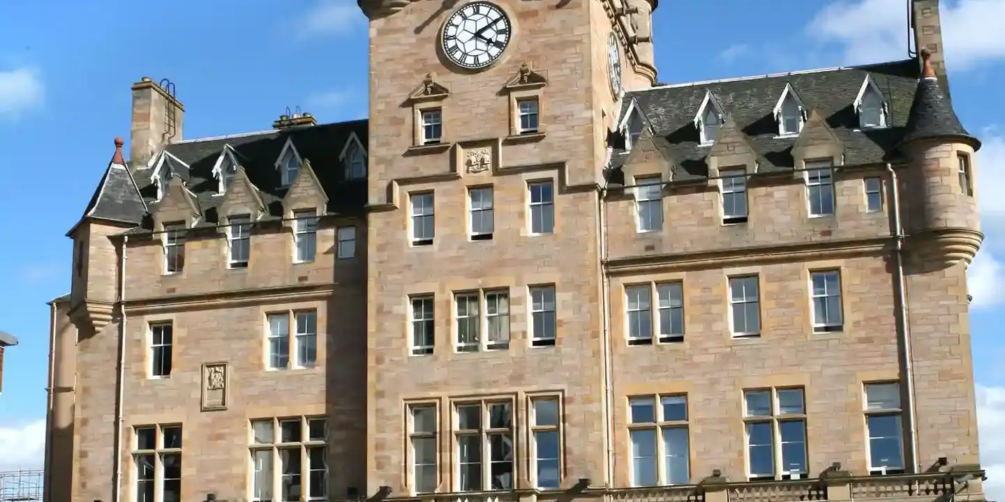 An imposing structure featuring a prominent clock atop.