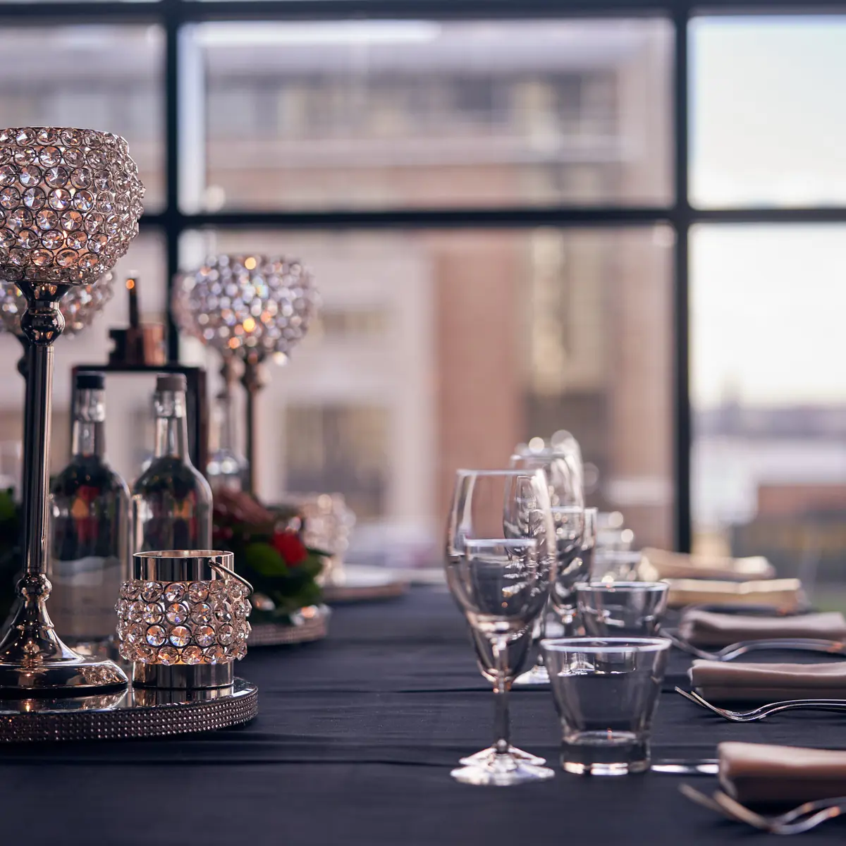 A beautifully arranged table adorned with elegant wine glasses and gleaming silverware.
