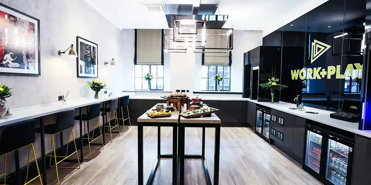 Kitchen featuring sleek black cabinets and a table adorned with delicious food.