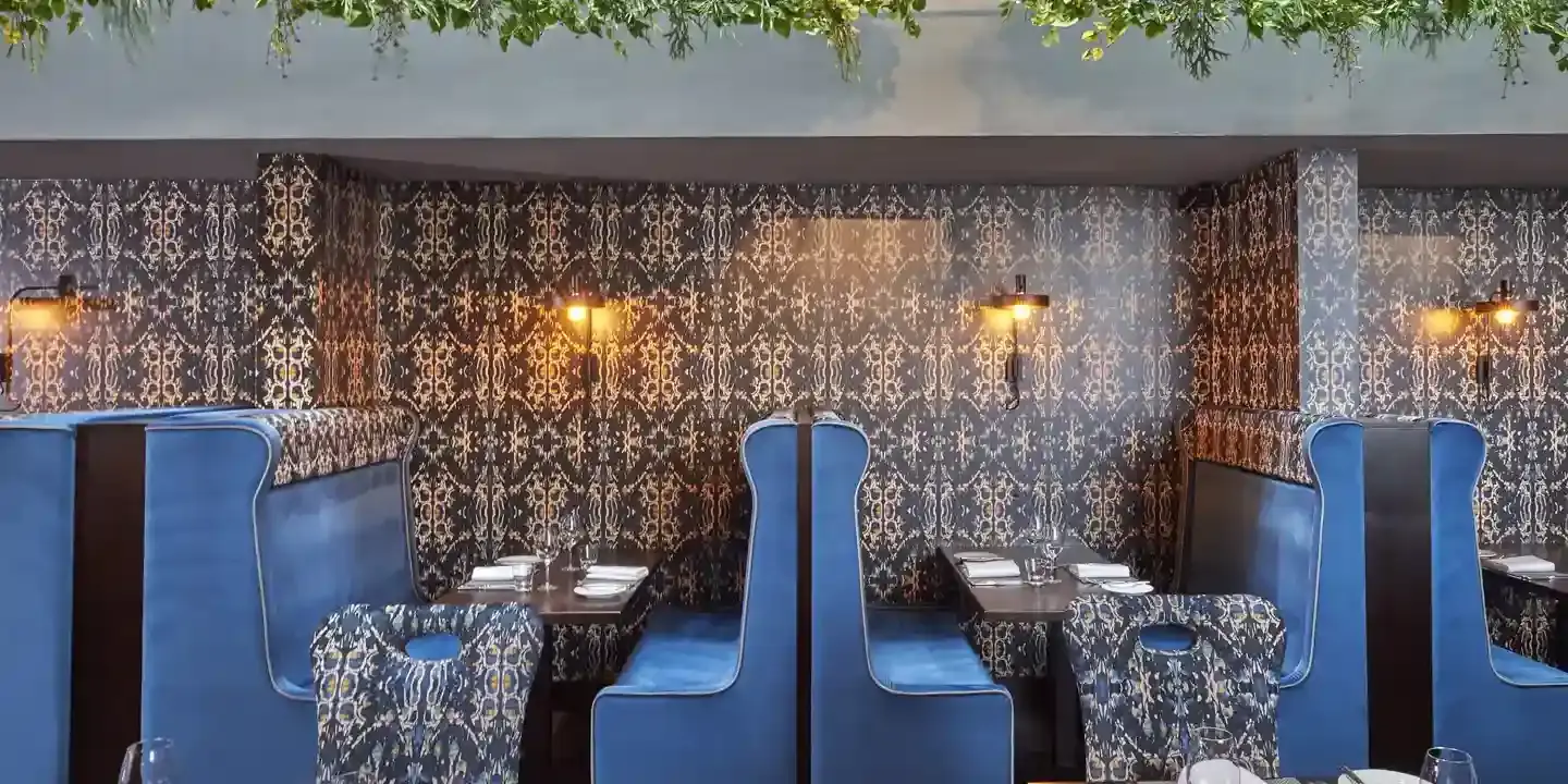 Malmaison Aberdeen Grill restaurant featuring blue booths and chairs.